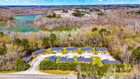 A bird's eye view of a residential area with houses and trees.