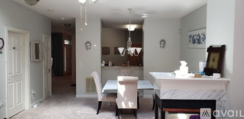 A dining room with a table and chairs.