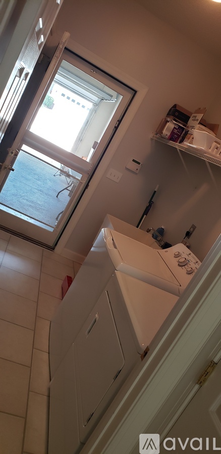 A white washing machine is in a kitchen.