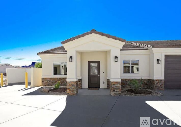 A modern house with a front yard and a driveway.