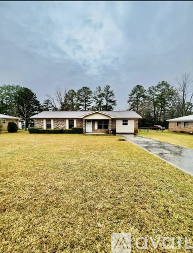 A house with a lawn in front of it.
