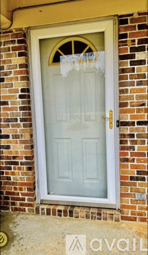 A white door with a glass panel and a gold handle.