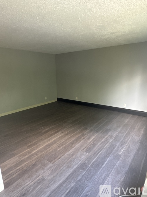 A room with wooden flooring and a white ceiling.