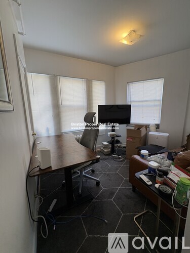 A room with a table, chairs, and a television.