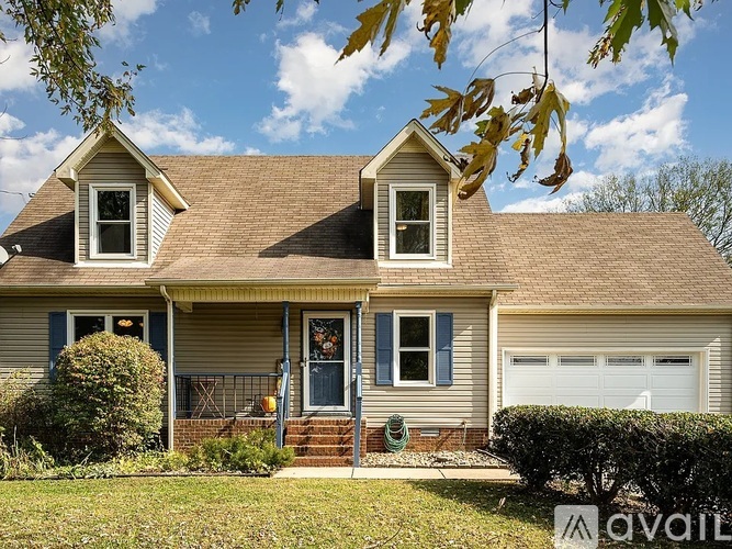 A house with a brown roof and a blue door is for sale.