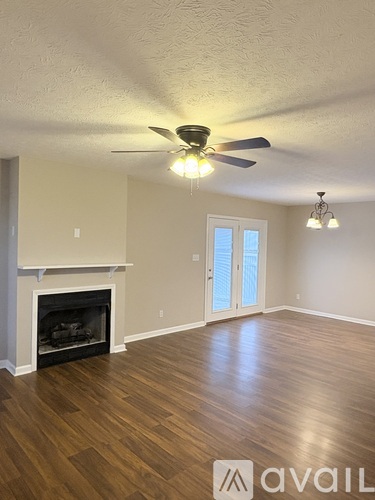 A room with a fireplace and a ceiling fan.