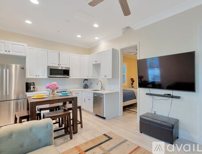 A modern kitchen with a dining table and chairs.