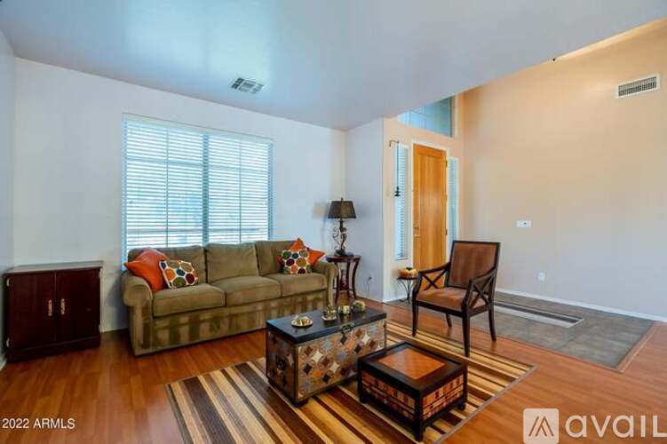 A living room with a couch, chair, and coffee table.
