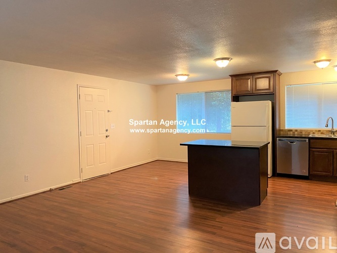 A kitchen with wooden cabinets and a white refrigerator.