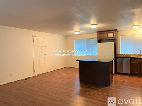 A kitchen with wooden cabinets and a white refrigerator.