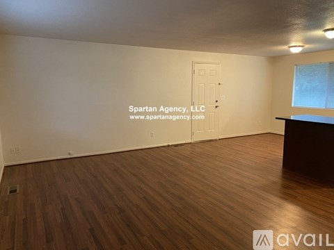 A large open space with a kitchen area and a reception desk.