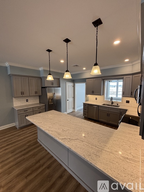 A kitchen with a large island in the middle.