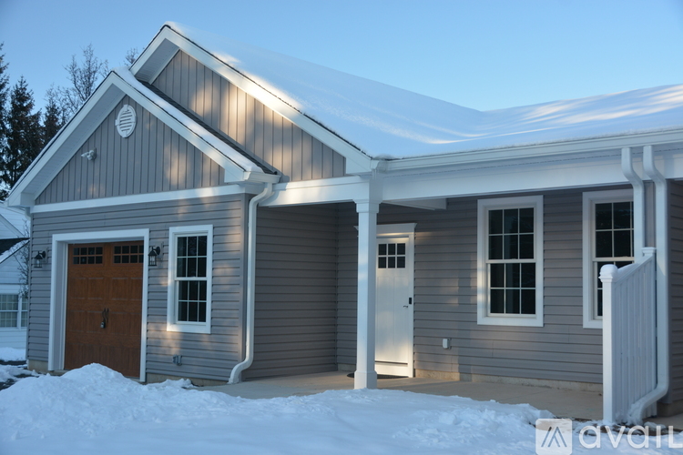 A house with a brown door and a white garage door.