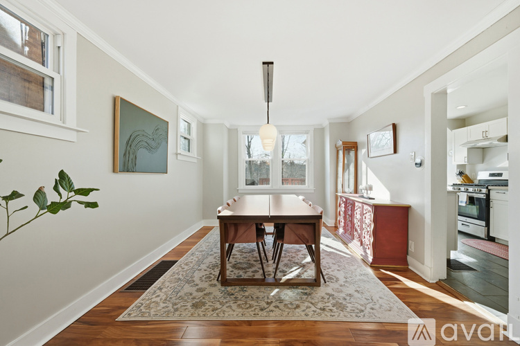 A dining room with a table and chairs.