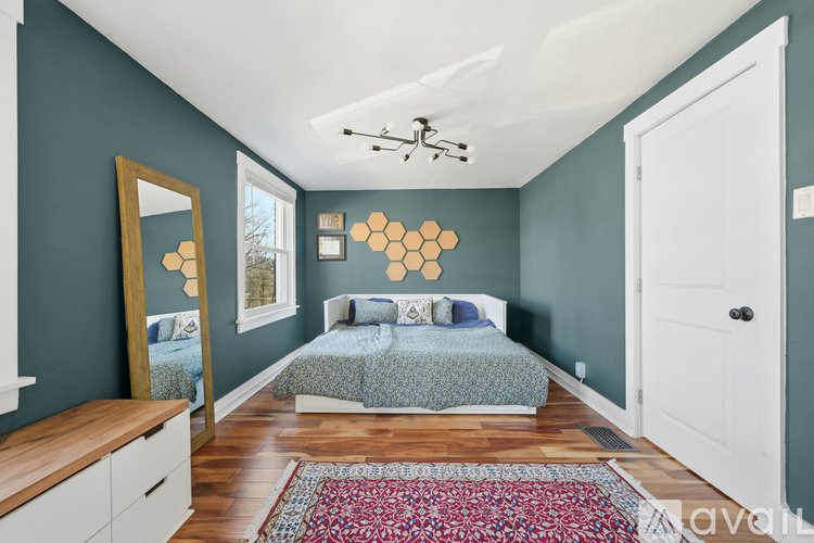 A bedroom with two beds and a white door.
