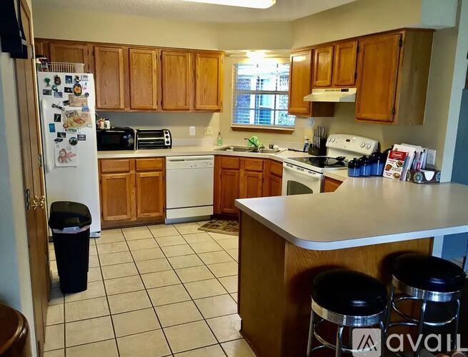 A kitchen with wooden cabinets and a white refrigerator.