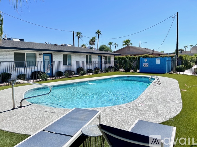 A swimming pool in a backyard with a slide.