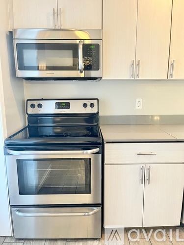 A kitchen with a stove, oven, and microwave.