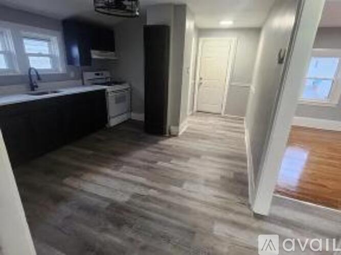 A kitchen with a white dishwasher and a white fridge.