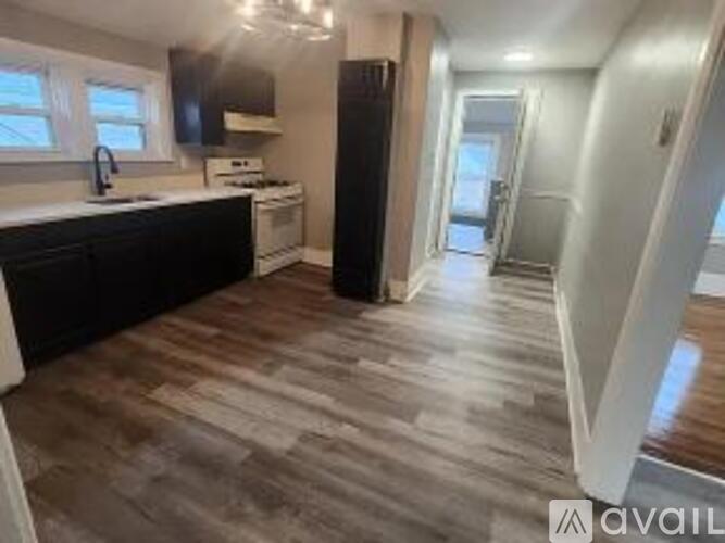 A kitchen with a sink, stove, and refrigerator.