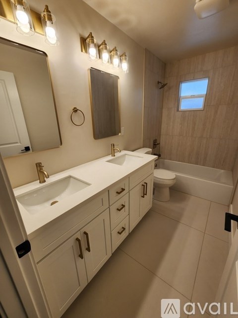 A bathroom with a white sink and a mirror above it.