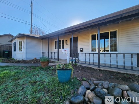A house with a front yard and a sign that says "AVAIL".