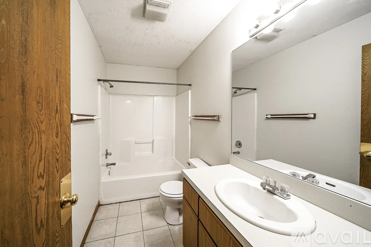A bathroom with a toilet, sink, and shower.