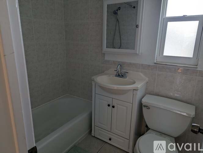 A bathroom with a white sink, toilet, and bathtub.