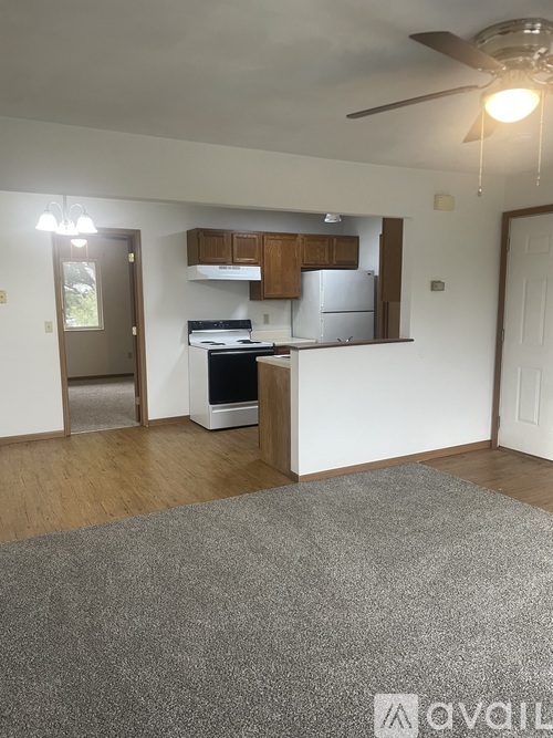 A kitchen with a refrigerator, oven, and cabinets.