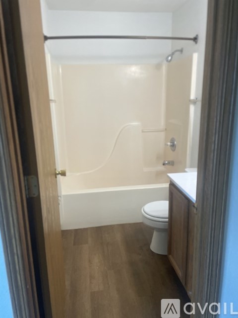 A small bathroom with a toilet, sink and bathtub.