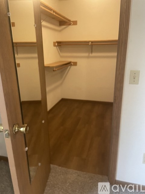 A wooden door with a handle and a glass window.