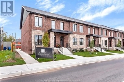 A row of houses with a sign that says REALTOR in front of them.