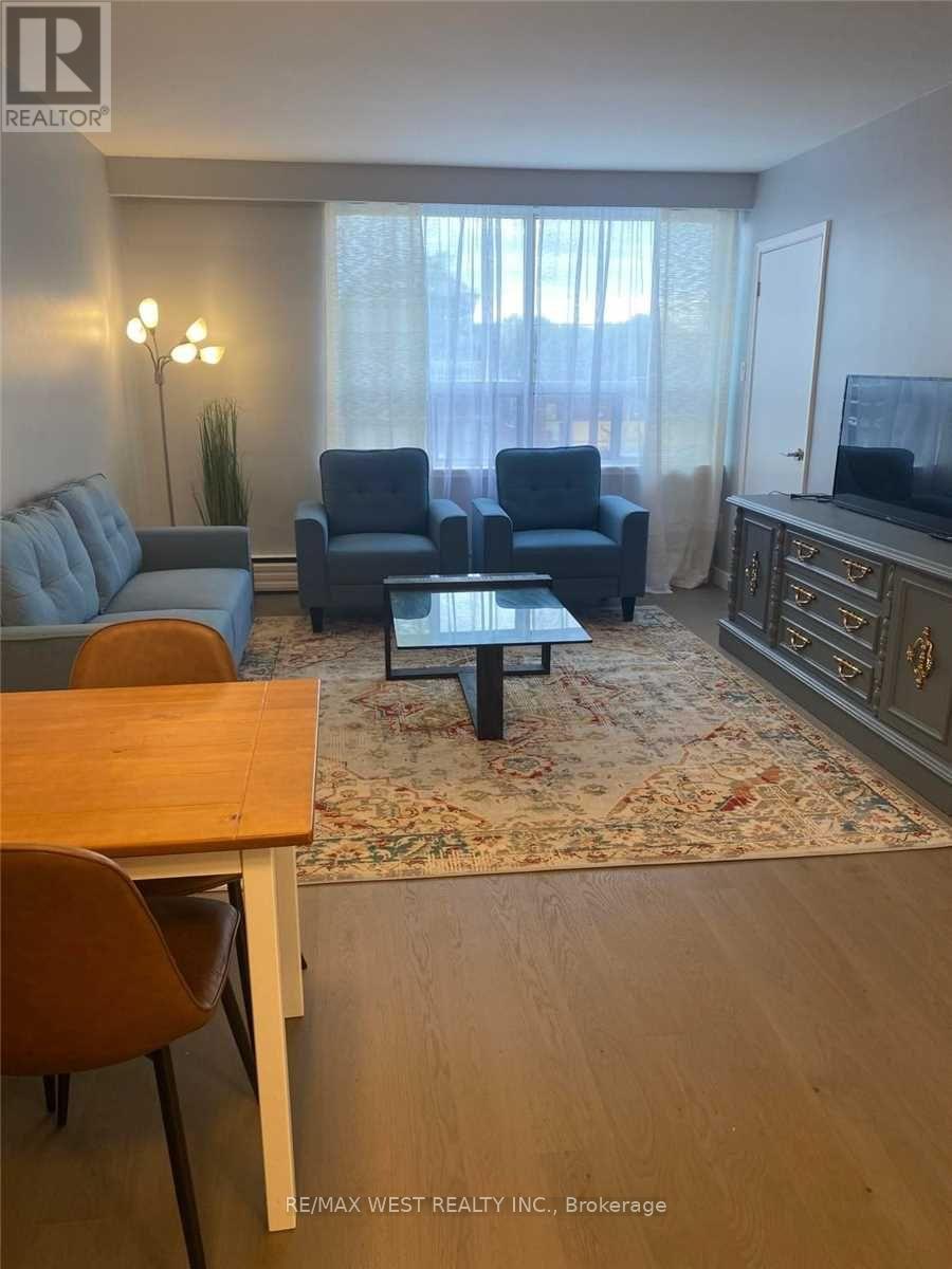 A living room with a grey couch, blue armchair, and a coffee table.