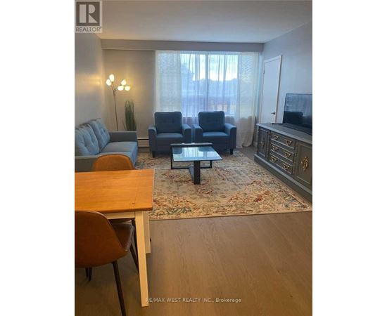 A living room with a grey couch, blue armchair, and a coffee table.