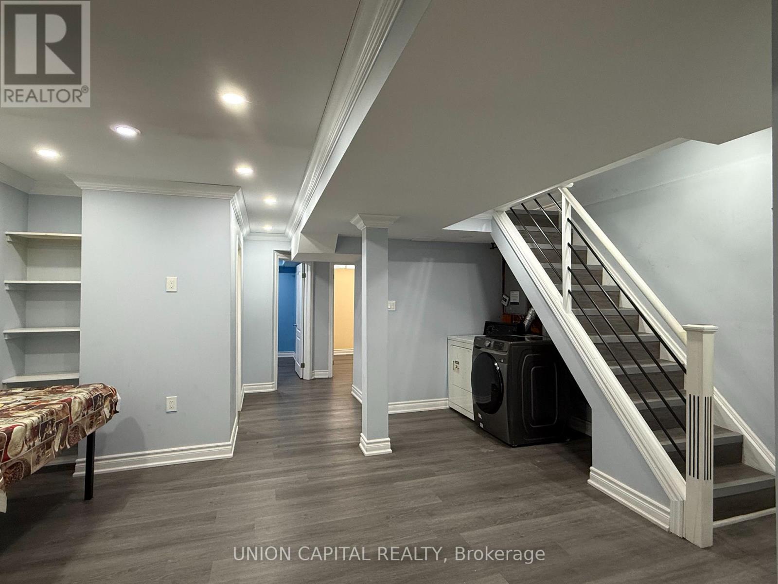 A bedroom with a staircase leading to the upper floor.
