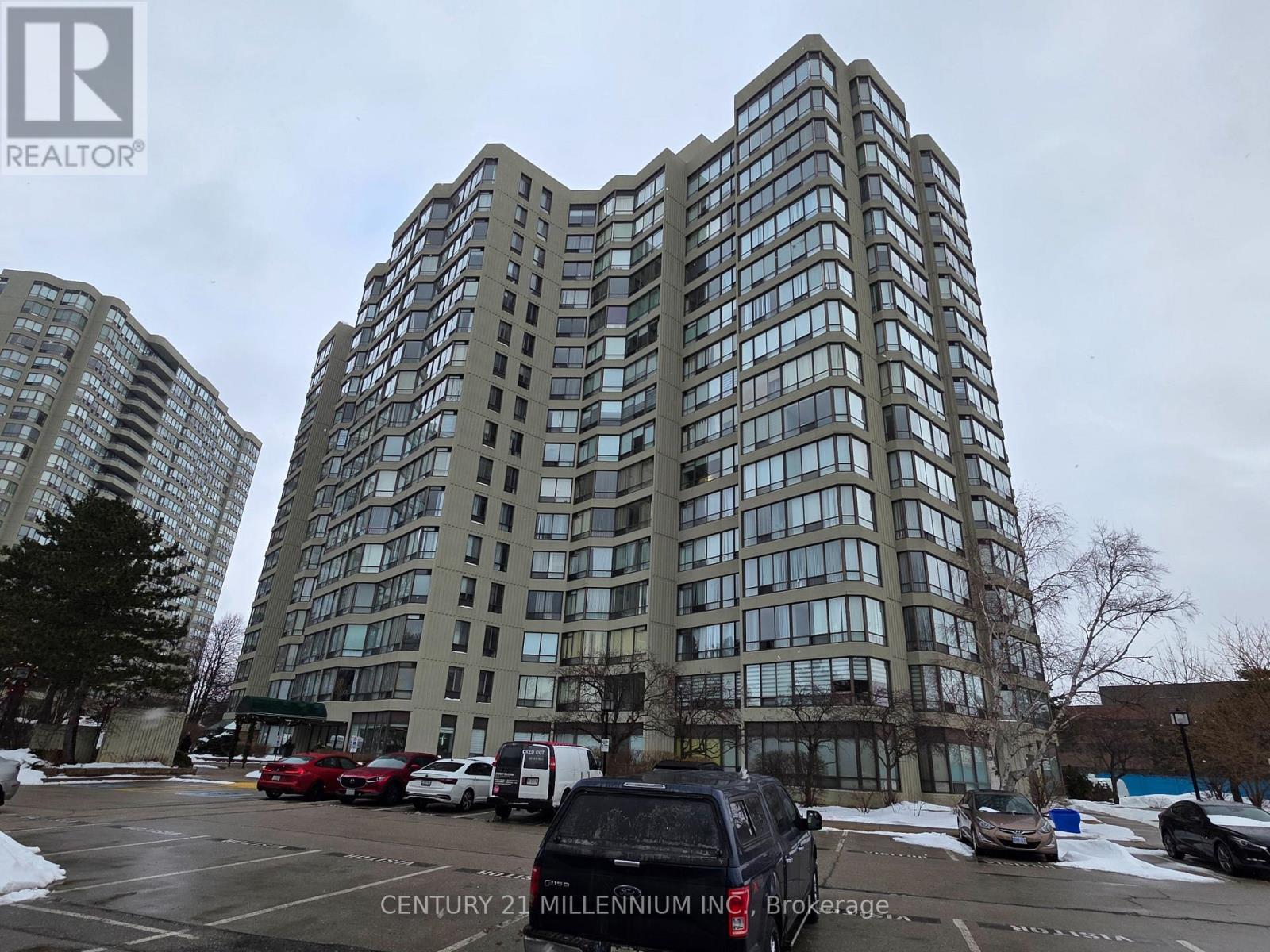 A tall building with the words Century 21 Millennium Inc. Brokerage on the side.