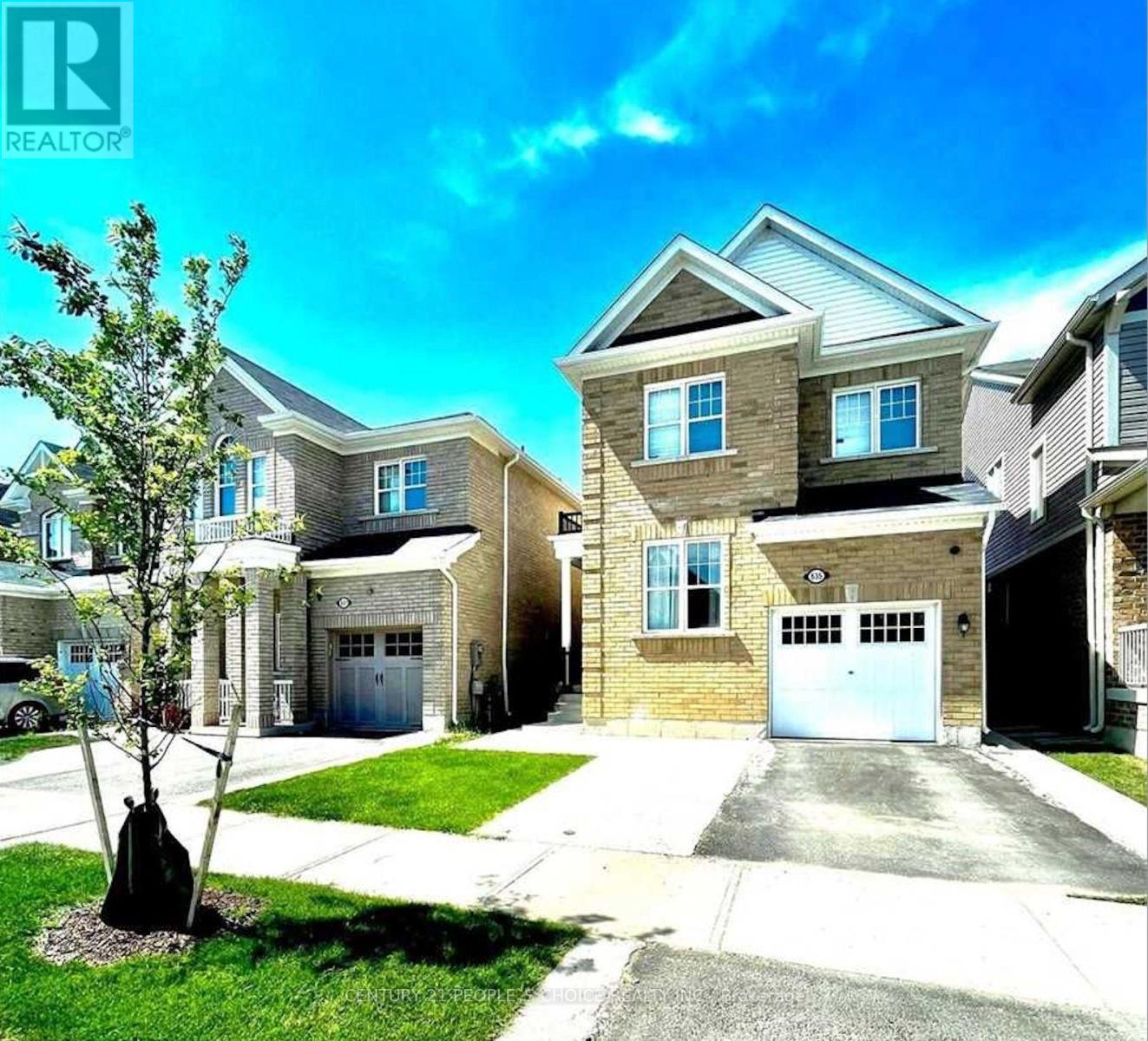 A realtor image of a house with a tree in front.