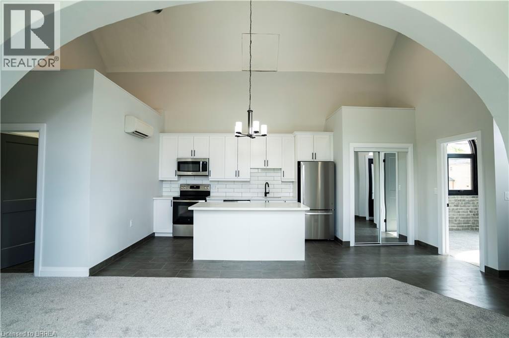 A modern kitchen with white cabinets and appliances.