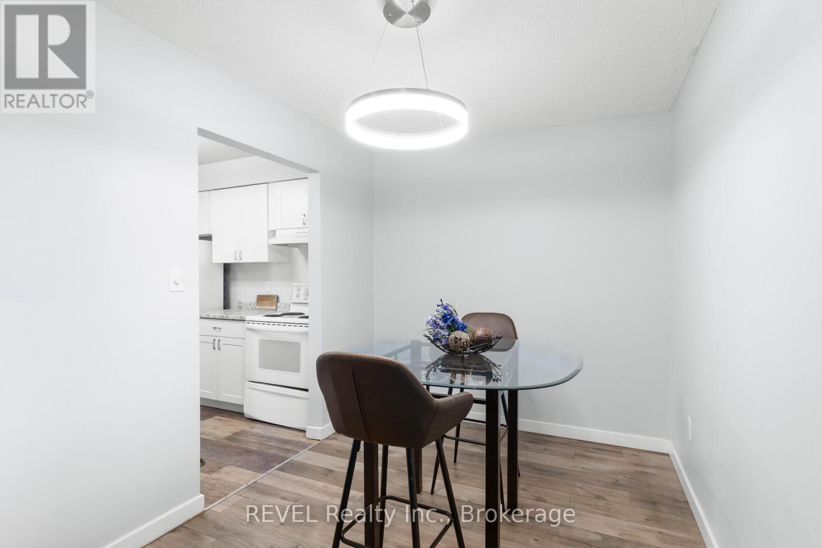 A dining room with a table and chairs.