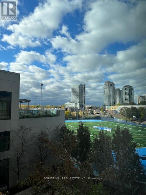 A view of a city from a high vantage point with buildings and a pool in the foreground.
