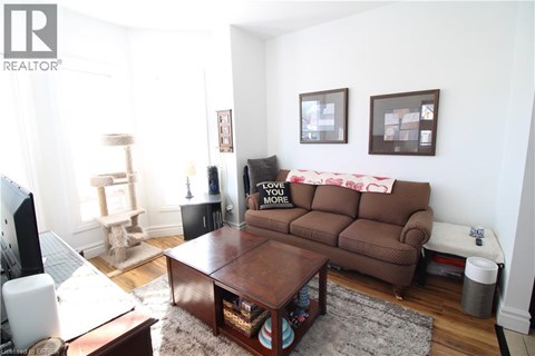 A living room with a brown couch and a coffee table.