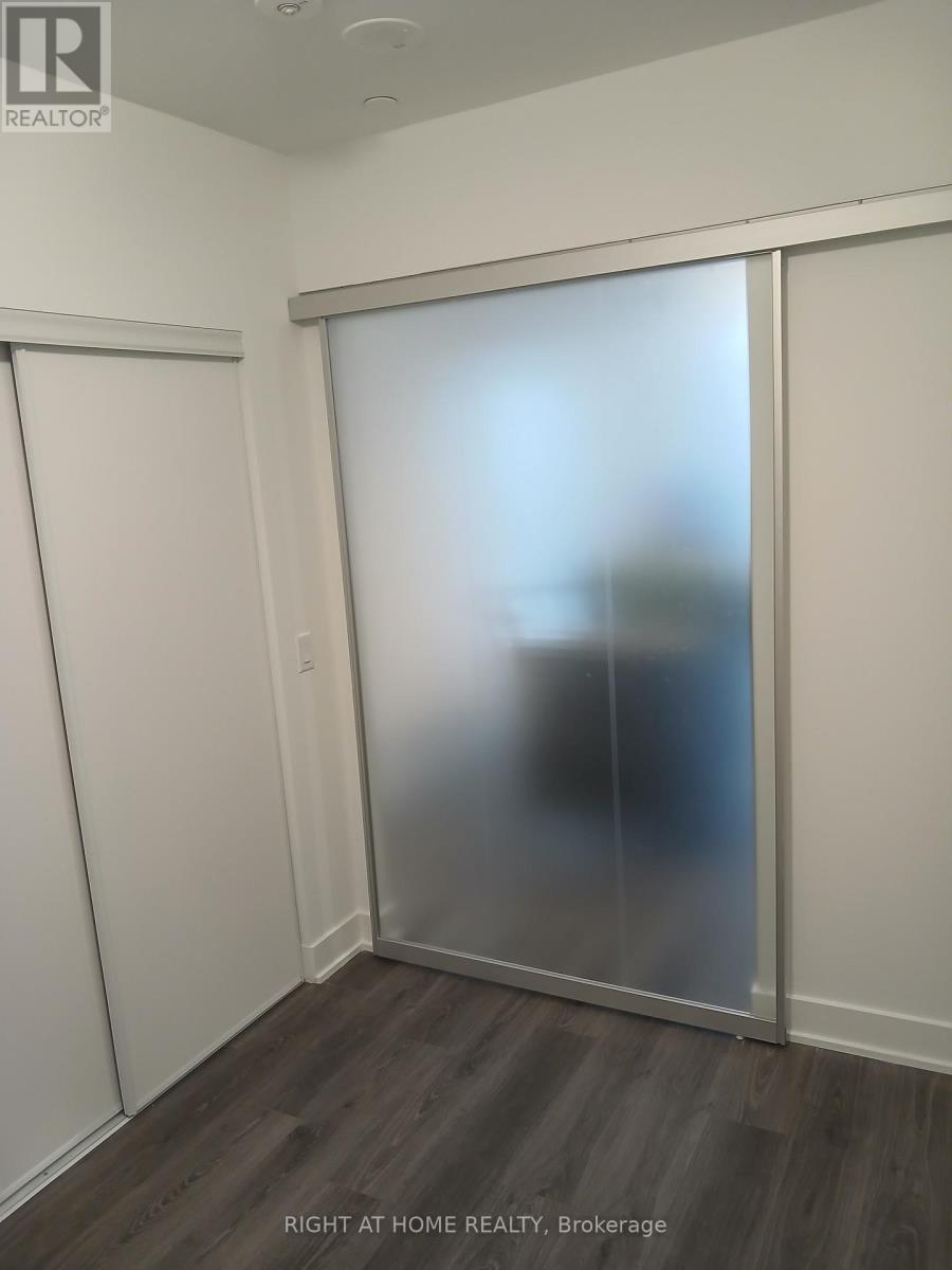 A room with a sliding door and a wooden floor.