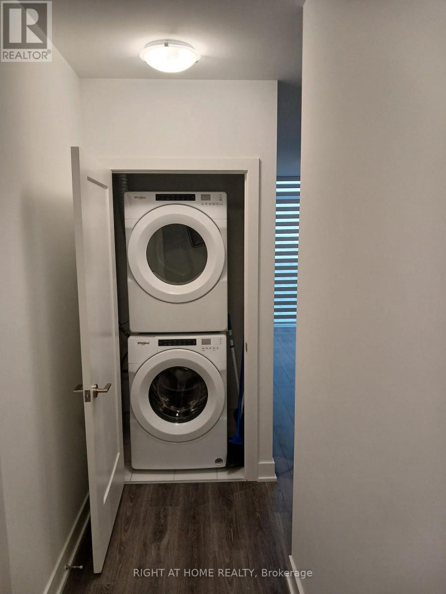 A small laundry room with a washer and dryer.