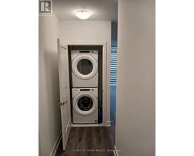 A small laundry room with a washer and dryer.