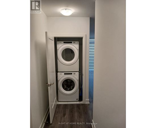 A small laundry room with a washer and dryer.