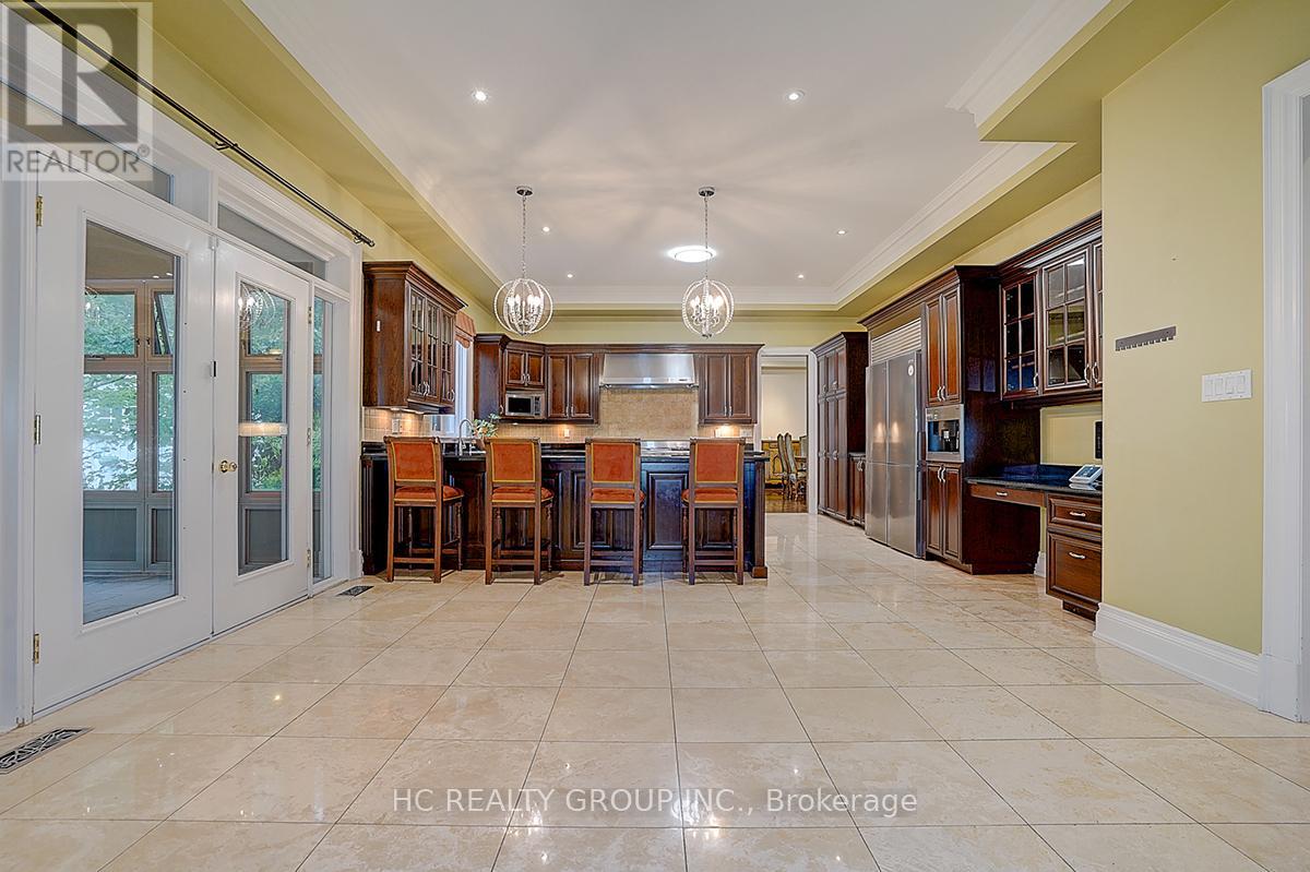 A spacious kitchen with a dining table and chairs.