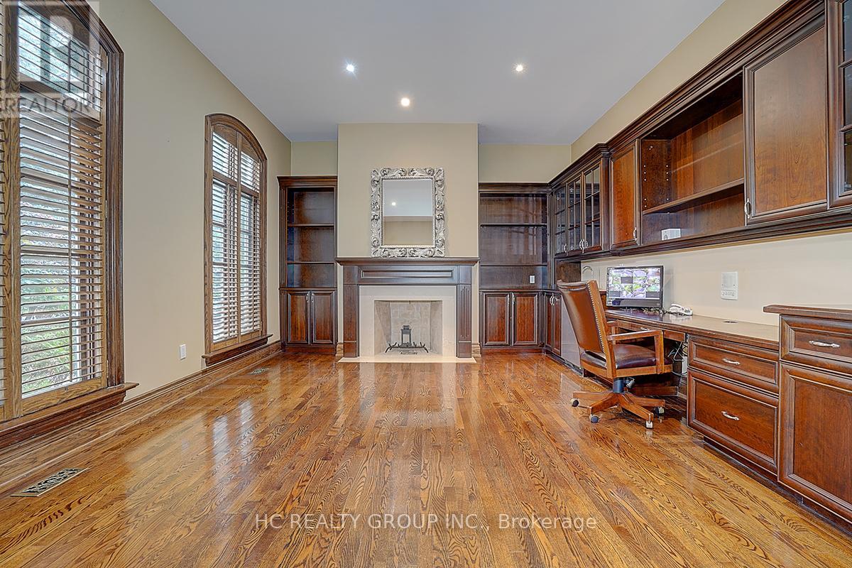A spacious living room with wood flooring and furniture.