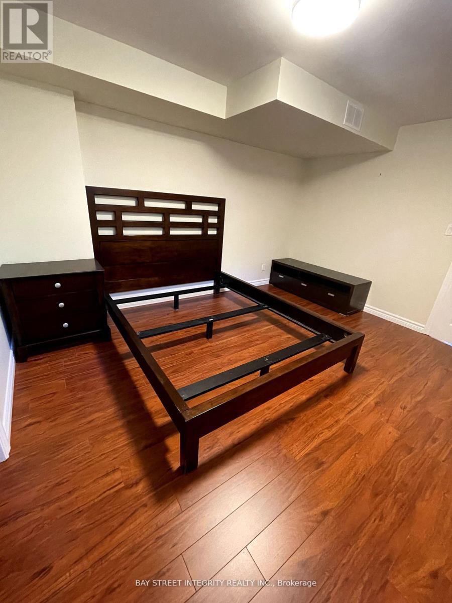 A bedroom with a bed, nightstand and dresser.