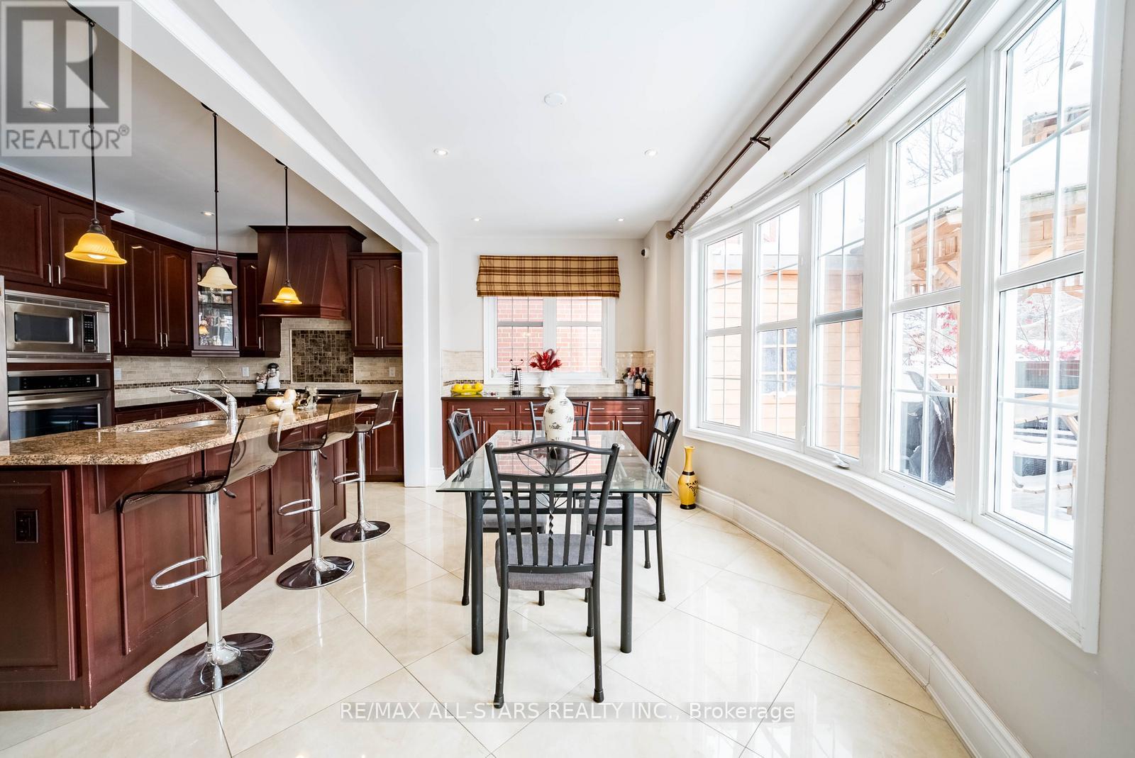 A kitchen with a table and chairs in the middle of it.
