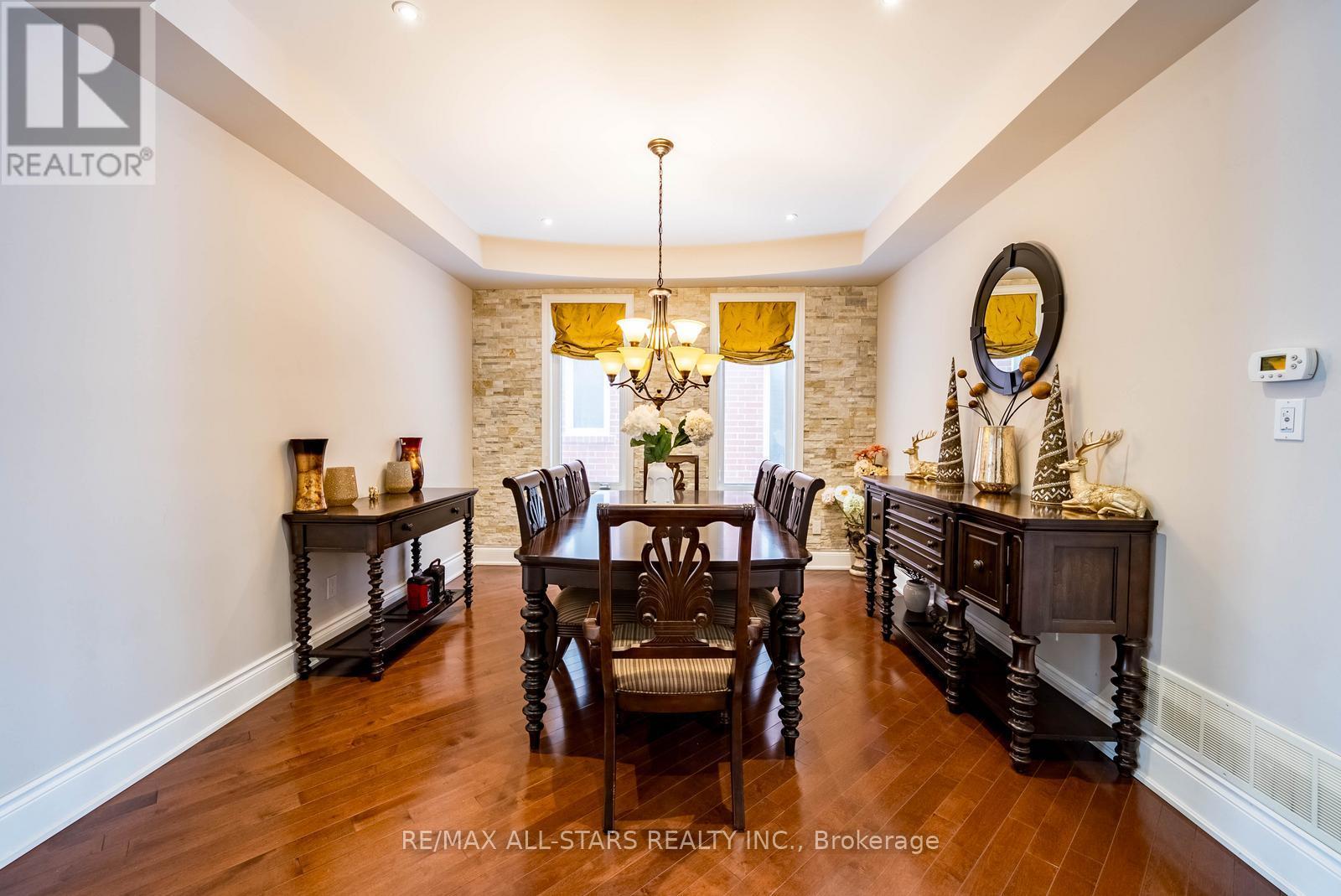 A dining room with a wooden table and chairs.